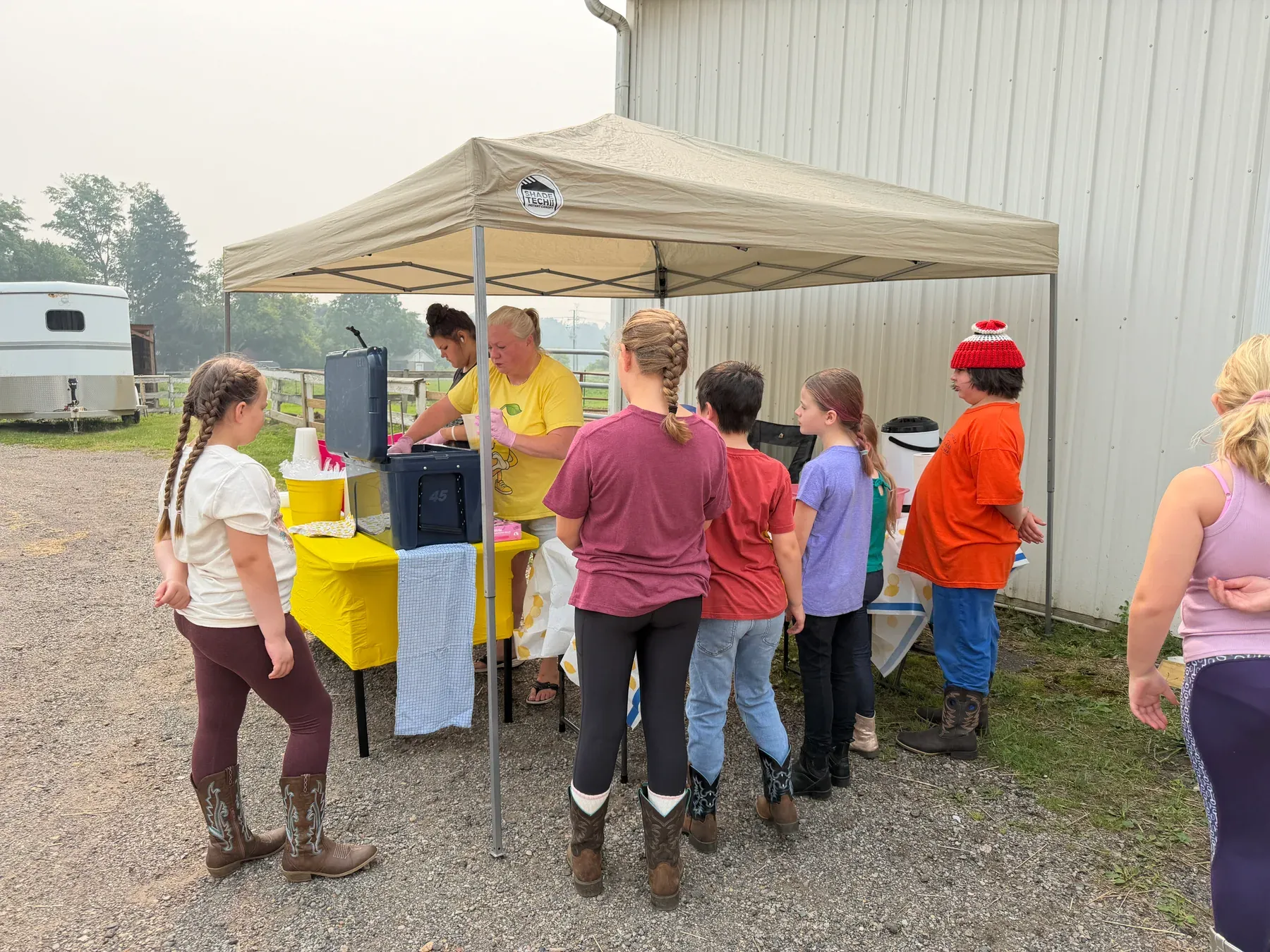 Campers gathered at an outdoor treat station during summer camp