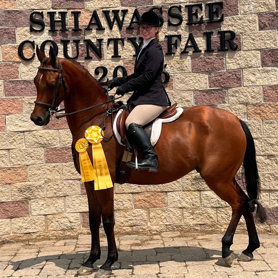 Melinda Blaine riding at the Shiawassee County Fair with award ribbons